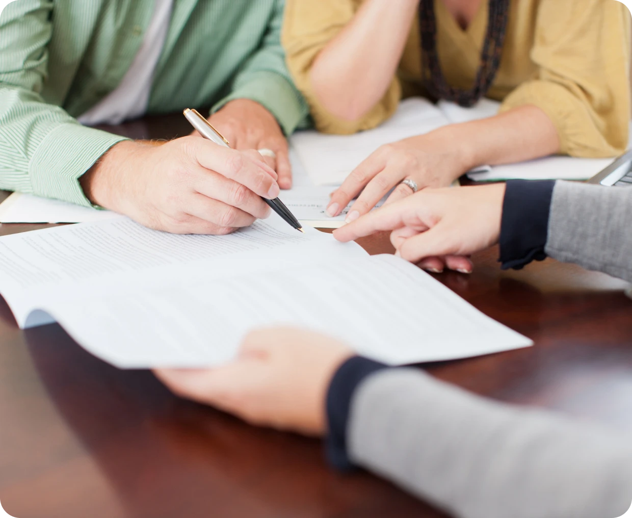 Hands pointing at contract document