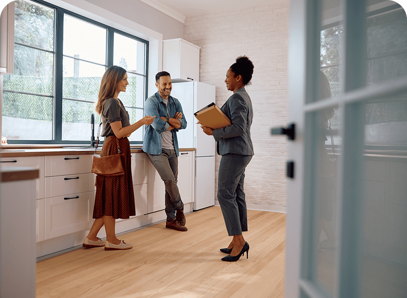 Couple touring modern kitchen with agent